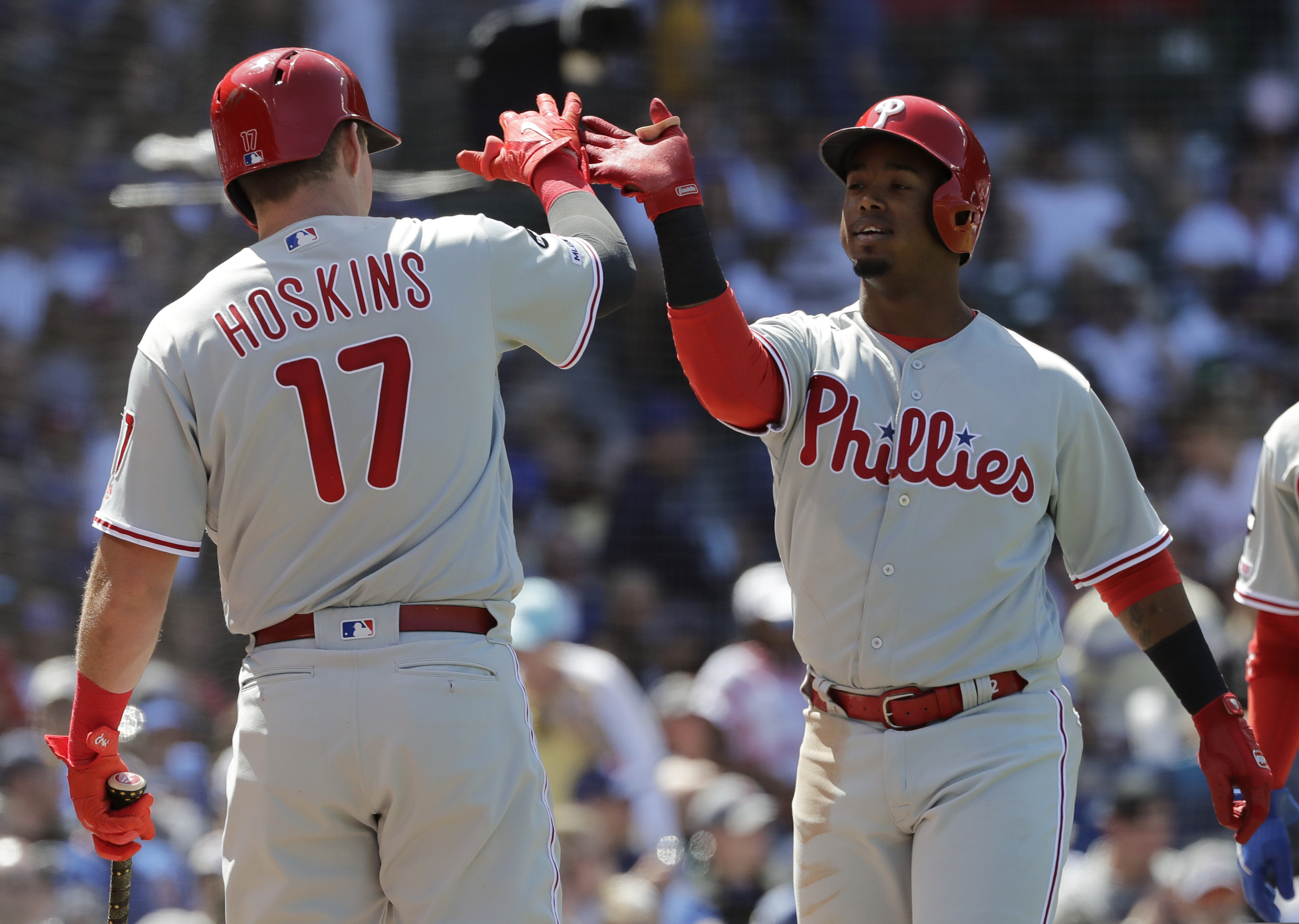 Shortstop Jean Segura celebrates with first baseman Rhys Hoskins after hitting a two-run homer in the fourth inning of the Phillies' 9-7 win against the Cubs on Thursday.