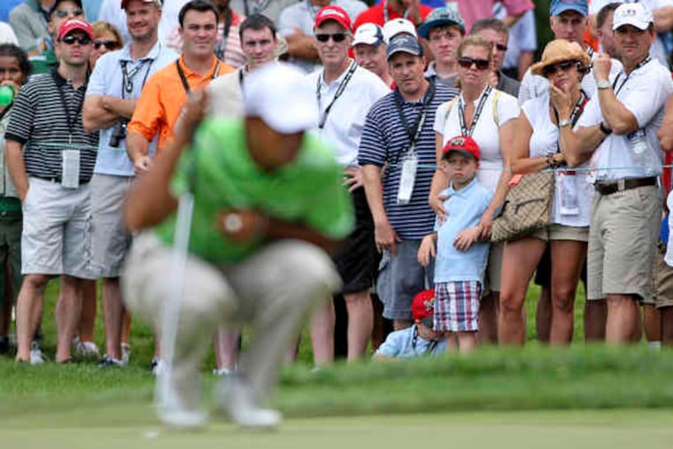 The Aronimink gallery watches Tiger Woods prepare to putt on the course's third green. Some other AT&T National attendees found nearby concessions tents more attractive.