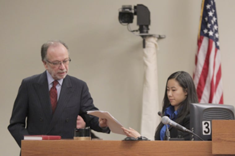 Defense attorney Steven Altman hands Molly Wei a copy of her statement to police during the trial of Dharun Ravi, charged with spying on his Rutgers roommate during an intimate encounter. (JOHN O'BOYLE / Newark (N.J.) Star-Ledger, Pool)