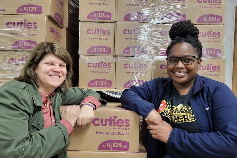 “I really wanted to start distributing directly to the public out of the warehouse, just to give back to the community that has been home to us for so long,” said Deneen Newland (right), operations manager for the Greater Philadelphia Diaper Bank. Mauri Rapp (left) and Newland distribute diapers from their Kensington warehouse.