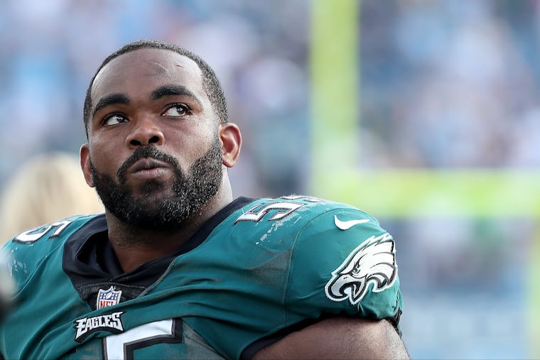 Brandon Graham walks off the field after the Titans game.