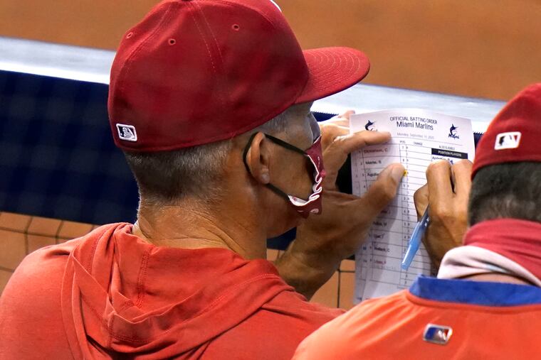 Phillies manager Joe Girardi looks at his lineup card during his team's loss to the Marlins on Monday in Miami.