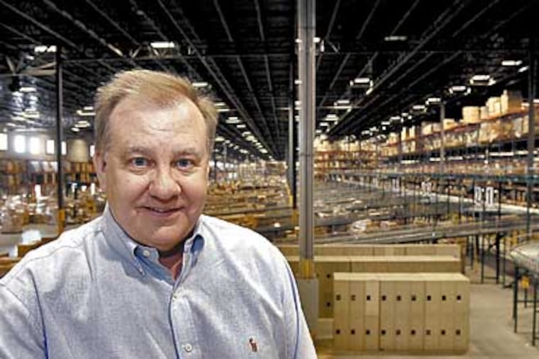 AC Moore CEO Rick Lepley sits at the company's huge warehouse in Berlin, NJ. Akira Suwa / Inquirer )