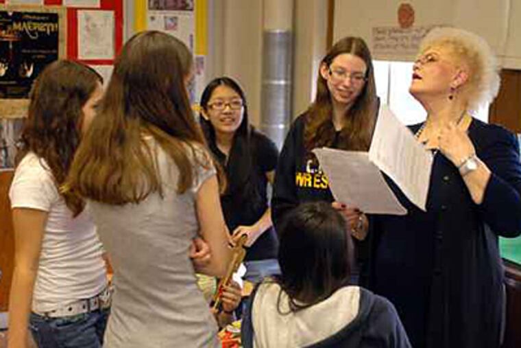 Students in an honors English class at Central High School meet with teacher Marian Geiger in this file photo. The Philadelphia School District is launching an Internet site just for students, where they can access all kinds of information from test scores to job opportunities. ( Tom Gralish / Staff / File )