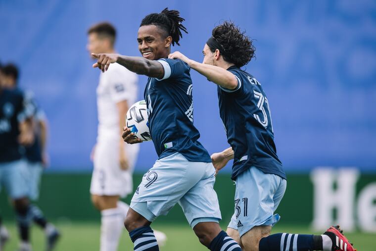 Vancouver forward Yordy Reyna (left) celebrates after scoring the opening goal in the Whitecaps' 2-0 win over the Chicago Fire.