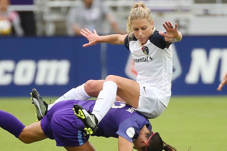 FILE - In this June 30, 2018, file photo, North Carolina Courage's McCall Zerboni, top, falls on Orlando Pride's Alex Morgan during an NWSL soccer game in Orlando, Fla. Zerboni is so dedicated to her soccer career that she once hawked random products to beachgoers in Southern California to make ends meet. Now 32, the savvy midfielder is getting her shot at the U.S. national team _ and a chance to make the roster for the World Cup this summer. She was named this week to the 23-player roster for the upcoming SheBelieves Cup tournament that kicks off Wednesday in Chester, Pennsylvania.(Stephen M. Dowell/Orlando Sentinel via AP, File)