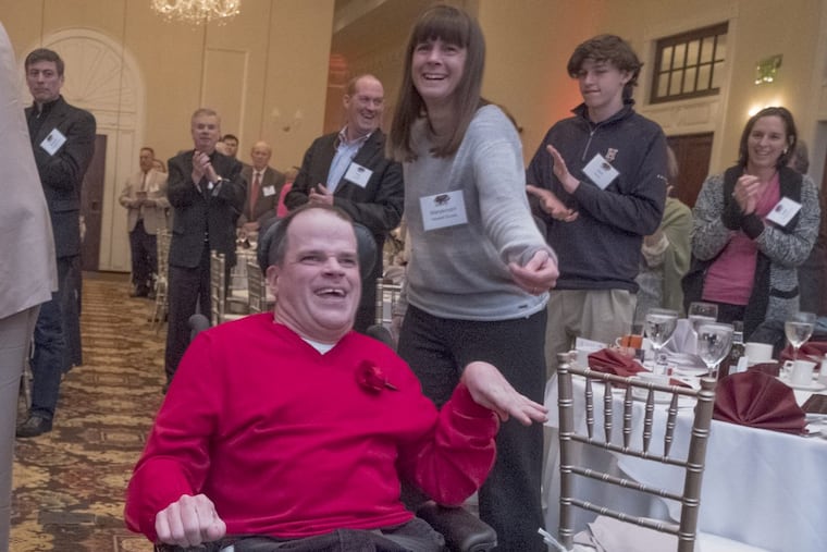 Chris DiJulia gets a standing ovation as he makes his way to the front of the ballroom for his induction into the St. Joe’s women’s basketball Hall of Fame.