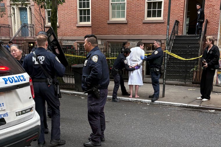 New York police officers arrest John Woeltz, Friday, May 23, 2025, in New York, who was charged with kidnapping, assaulting, and holding a man against his will for several weeks in an upscale Manhattan townhouse.