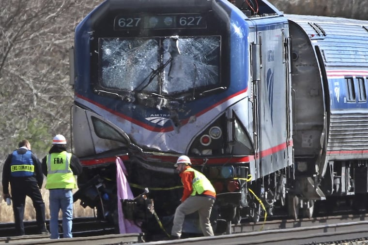 FILE – In this April 3 2016, file photo, investigators inspect the Amtrak train involved in a the deadly crash in Chester, Pa. which killed two workers and injured 39 passengers. The train struck a backhoe just south of Philadelphia causing a derailment. The National Transportation Safety Board on Tuesday, Nov. 14, 2017, in Washington, was clearly appalled by Amtrak’s awful safety culture. (Michael Bryant/The Philadelphia Inquirer via AP, File)