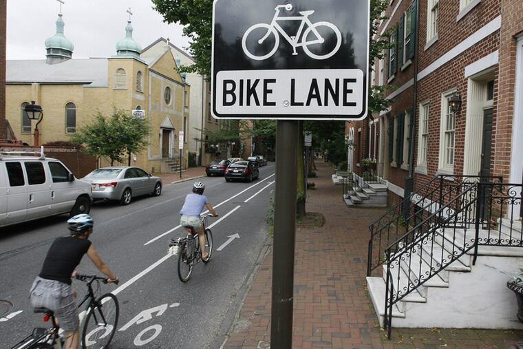 In the wake of a cyclist’s death in November, advocates renewed demands for protected bicycle lanes, which include physical dividers like posts, planters, and even parked cars.