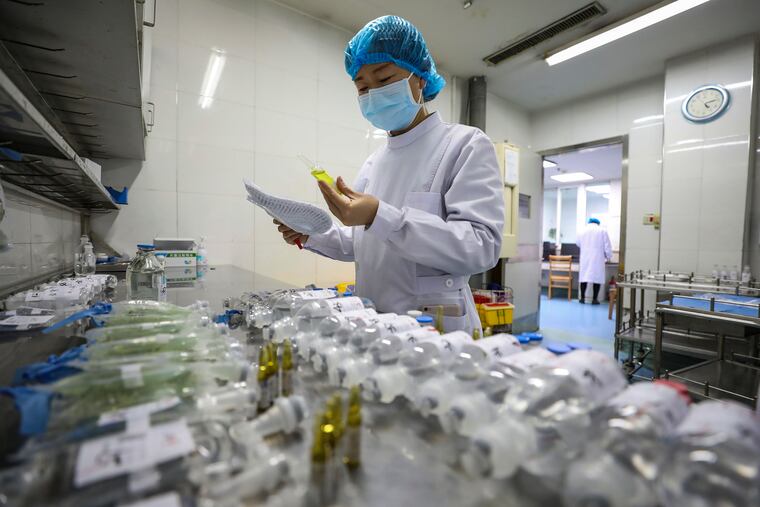 A nurse prepares medicine for coronavirus patients at Jinyintan Hospital in Wuhan, the epicenter of the outbreak, earlier this week. The respiratory illness has strained China's health-care system.