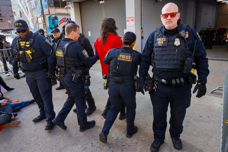 Carrie Rathmann of West Philadelphia gets arrested by officers with U.S Department of Homeland Security during a protest outside the Philadelphia Immigration and Customs Enforcement office in March.