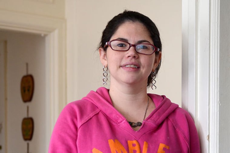 Meagan Bergbauer, a former Marine, poses in her apartment in the Overbrook section of West Philadelphia, December 31, 2013. Due to the VA's Pathways program she has moved off the streets and shelters and into permanent housing. ( TOM GRALISH / Staff Photographer )