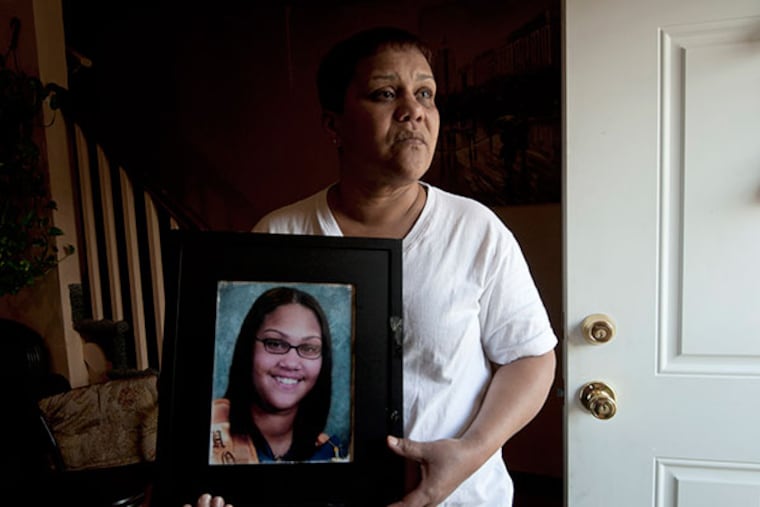 Carmen Feliciano holds a picture of her daughter, Eveline Heredia, who died in the Camden County Jail at her East Camden home on Feb. 27th, 2014. ( APRIL SAUL / Staff )