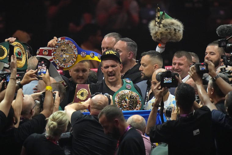 Ukraine's Oleksandr Usyk celebrates after beating Britain's Tyson Fury in their undisputed heavyweight world championship bout.