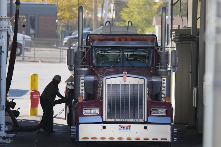 A trucker loads his truck with fuel at the Marathon Oil Refinery in Salt Lake City, Utah on Oct. 29, 2021. Prices for gasoline are expected to hit $4 a gallon soon and could go higher if Russia holds back on oil and gas shipments. But that is unlikely, Mark Zandi writes, because it would throw even more chaos into a beleaguered Russian economy. (George Frey/AFP/Getty Images/TNS)