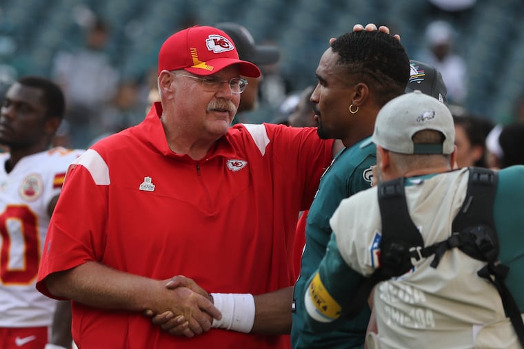 Chiefs head coach Andy Reid speaks with Eagles quarterback Jalen Hurts after Kansas City's victory Sunday.