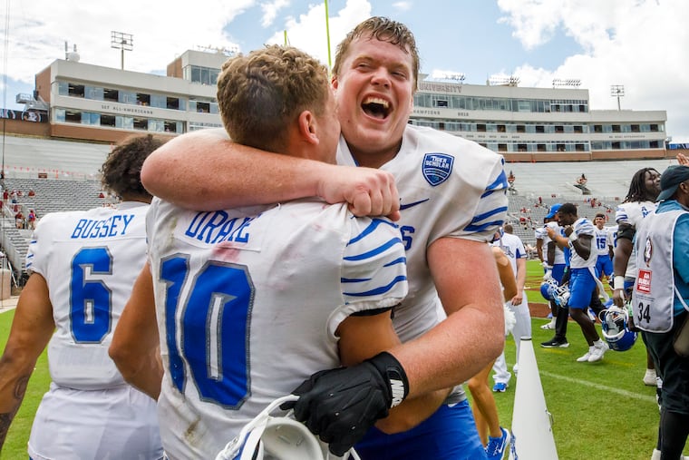 Memphis wide receiver Koby Drake and offensive lineman Jonah Gambill celebrate after defeating Florida State, 20-12, on Sept. 14.