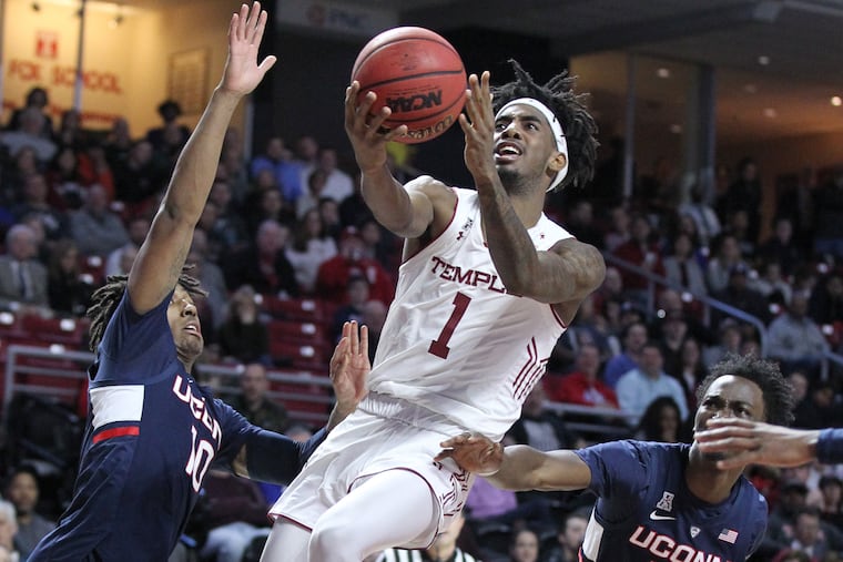 Quinton Rose of Temple splits Brendan Adams (left) and Sidney Wilson of Connecticut as he goes up for a basket at the Liacouras Center.