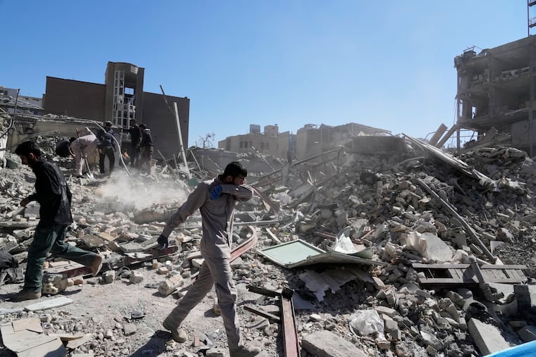 A group of men inspects the ruins of a police station struck Monday amid the U.S.–Israeli military campaign in Tehran, Iran, Tuesday, March 3, 2026.