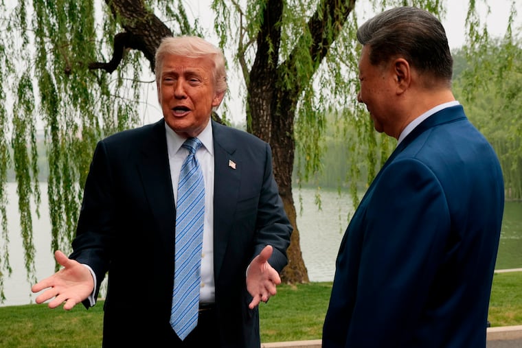U.S. President Donald Trump, left, speaks as he is greeted by Chinese President Xi Jinping at Zhongnanhai Garden in Beijing, China, Friday, May 15, 2026.