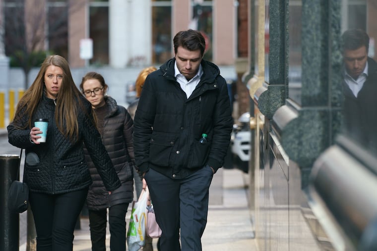 Jack Miley, center, former roommate of accused murderer Joshua Hupperterz, and his older sister, Courtney Miley (left), return to the Criminal Justice Center after a lunch break Friday, Jan. 11.