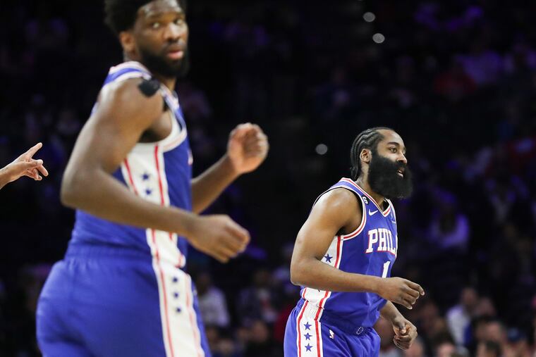 The Sixers' Joel Embiid and James Harden run down the floor in the first half of a game against the Orlando Magic at the Wells Fargo Center.