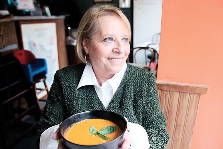 Valerie Blum of Cafe Lutecia holds a bowl of soup at her restaurant in Philadelphia on January 22, 2015. ( DAVID MAIALETTI / Staff Photographer )