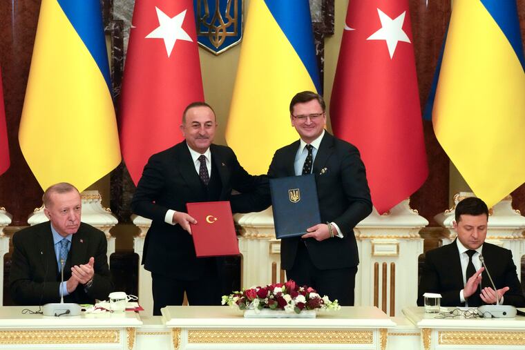 Ukrainian President Volodymyr Zelenskyy (right) and Turkey President Recep Tayyip Erdogan (left) applaud as Turkish Foreign Minister Mevlut Cavusoglu (second left) and Ukrainian Foreign Minister Dmytro Kuleba pose for a photo during a signing ceremony in Kyiv, Ukraine, on Thursday.