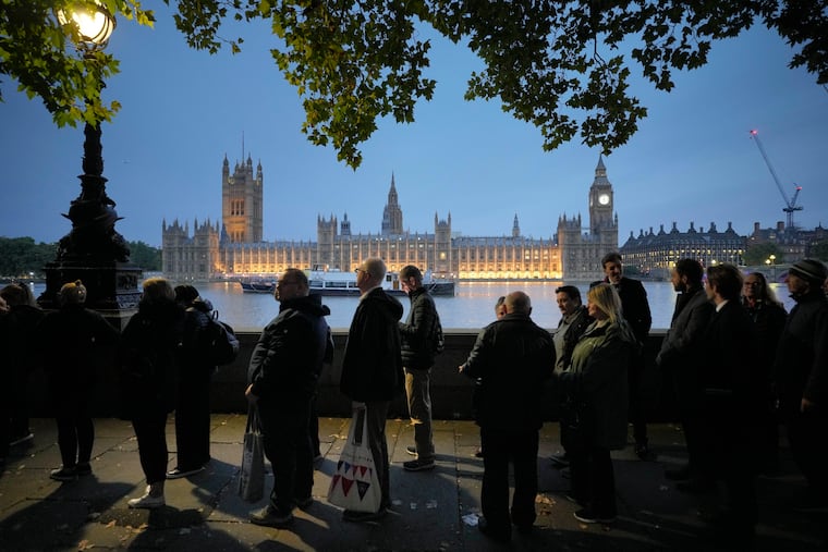 People queue to pay their respect to the late Queen Elizabeth II during the lying in state at Westminster Hall in London on Thursday.