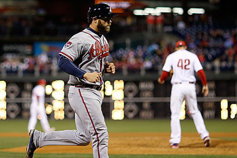 The Braves' Evan Gattis rounds the bases after hitting a home run off Phillies starting pitcher Cliff Lee in the fourth inning. (Matt Slocum/AP)