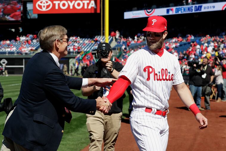Phillies star Bryce Harper, right, shakes hands with owner John Middleton before the 2019 season opener at Citizens Bank Park.