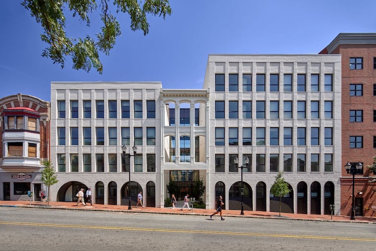 Digsau Architects incorporated brick arches into a residential project called the Cooper on Wilmington's Market Street. The design preserves the facade of a historic cast iron building and uses it as the building's entrance.