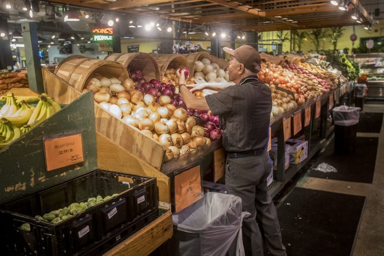 A customer looks through the onion selections at Iovine Brothers Produce at the Reading Terminal Market in Philadelphia. The market sees more food-stamp purchases than almost any other single location in Pennsylvania.