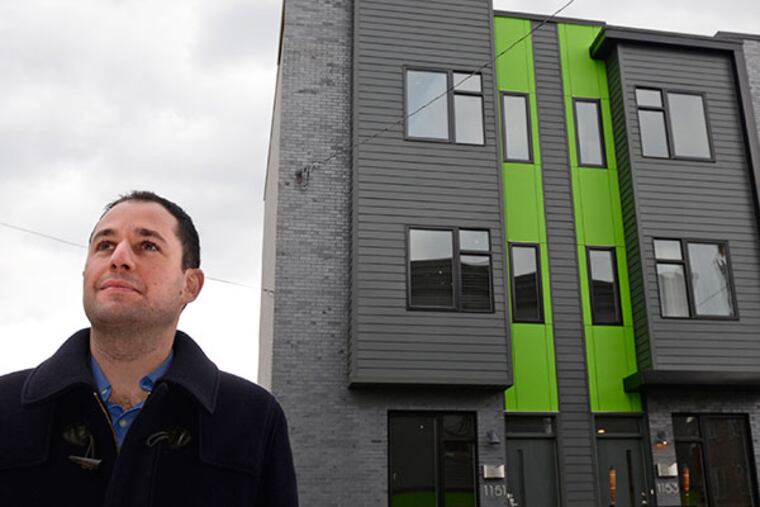 Point Breeze real estate developer Ori Feibush stands in front of the three single family homes he built at 20th and Federal Streets on November 8, 2013. ( TOM GRALISH / Staff Photographer )