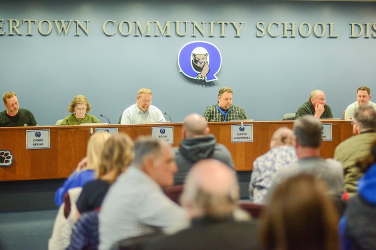 Quakertown school board members listen to the crowd at a Feb. 26 meeting focused on the district's response to the student ICE protest that ended in a clash with police.