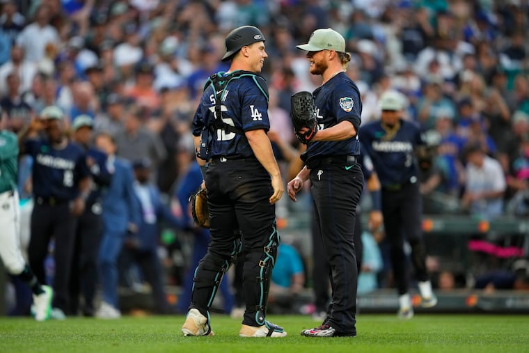 National League catcher Will Smith of the Dodgers greets the Phillies' Craig Kimbrel after defeating the American League 3-2 in the MLB All-Star baseball game on Tuesday in Seattle.