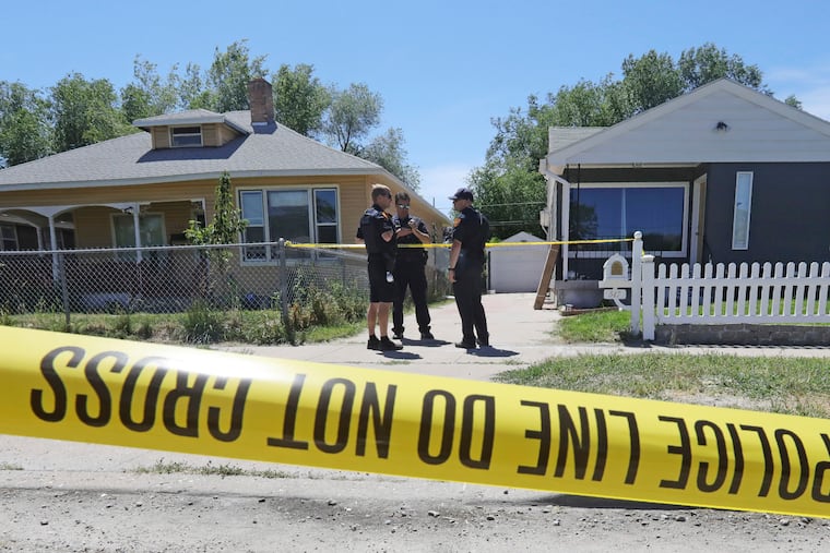 Police officers stand in front of the home, right, of Ayoola A. Ajayi Friday, June 28, 2019, in Salt Lake City. Authorities are filing murder and kidnapping charges in the death of a Utah college student who disappeared 11 days ago. Salt Lake City police chief Mike Brown said 31-year-old Ajayi will be charged with aggravated murder, kidnaping and desecration of a body in the death of 23-year-old Mackenzie Lueck.