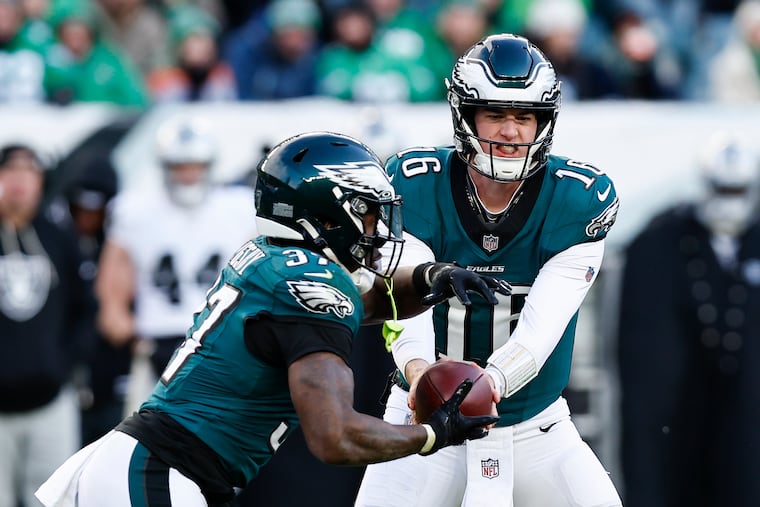 Eagles quarterback Tanner McKee hands off the football to running back Tank Bigsby against the Las Vegas Raiders in the fourth quarter on Sunday, December 14, 2025 in Philadelphia.