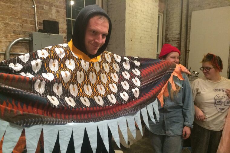 Gregory Labold tries on a costume he made for the Rabble Rousers performance in the Mummers Parade.