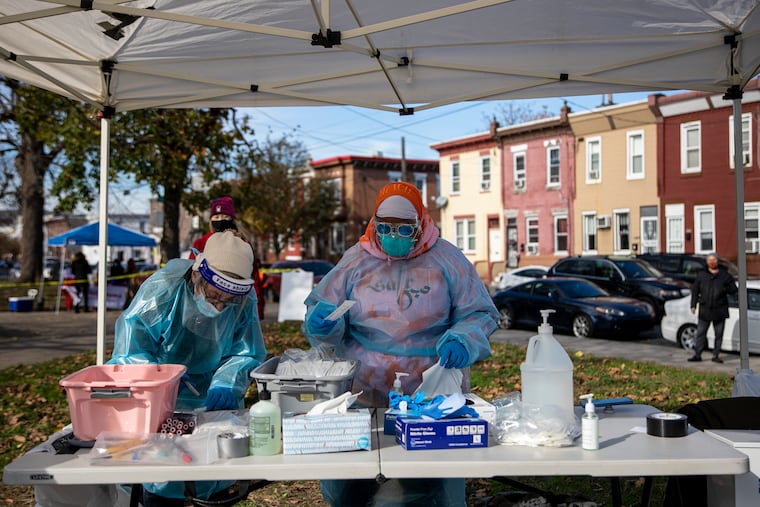 Volunteers conducting the COVID-19 testing sanitize and prep their station for every new person getting tested at Mifflin Square Park with Philadelphia Flight and SEAMAAC in South Philadelphia, Pa., on Thursday, Nov. 19, 2020.