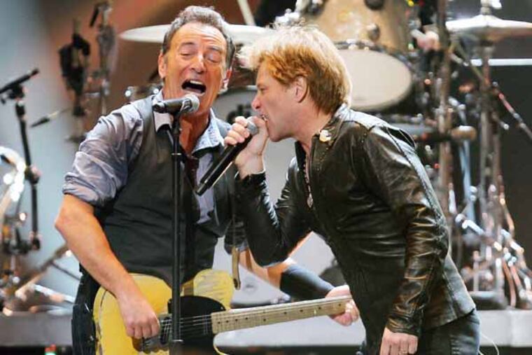 Bruce Springsteen and Jon Bon Jovi perform at the 12-12-12 Hurricane Sandy relief concert at Madison Square Garden in New York. DAVE ALLOCCA / Associated Press
