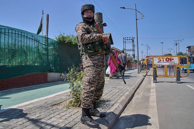 An Indian paramilitary soldier stands guard at a temporary checkpoint in Srinagar, in Indian-controlled Kashmir, on Wednesday, April 30, 2025.