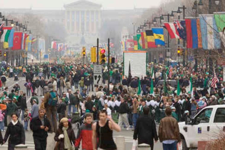 People swarm the Benjamin Franklin Parkway for the city's 239th St. Pat's parade, which covered a shortened route from 16th Street and JFK Boulevard to Eakins Oval in front of the Art Museum.