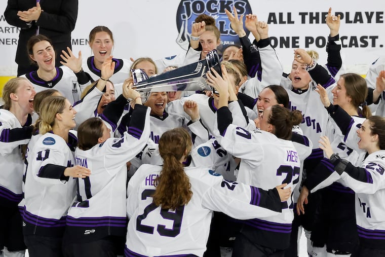 Minnesota players celebrate with the Walter Cup after defeating Boston to win the PWHL Walter Cup in May.