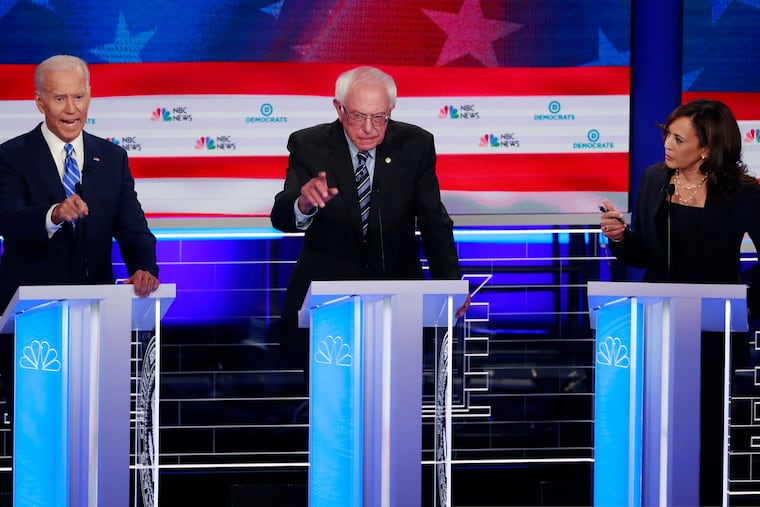Former vice president Joe Biden (left), Sen. Bernie Sanders (I., Vt., center), and Sen. Kamala Harris speak simultaneously during a Democratic primary debate last month.