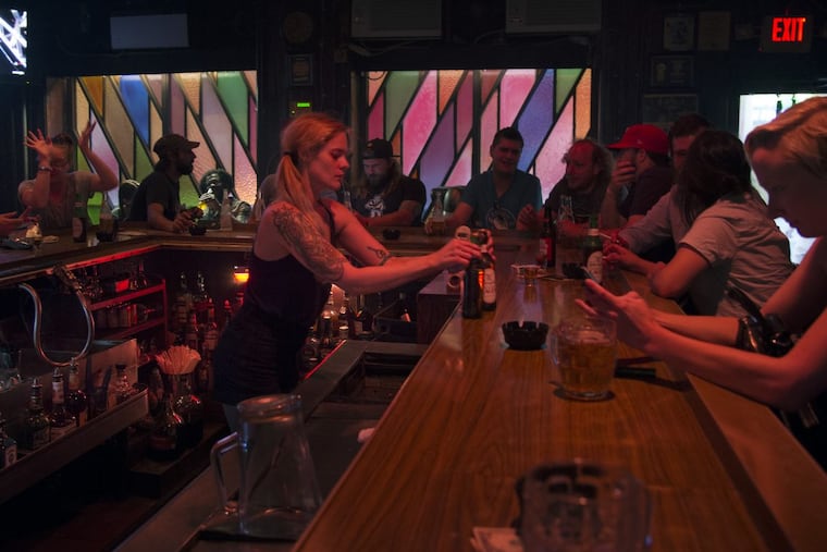 Bartender Ren serves drinks at McGlinchey's.