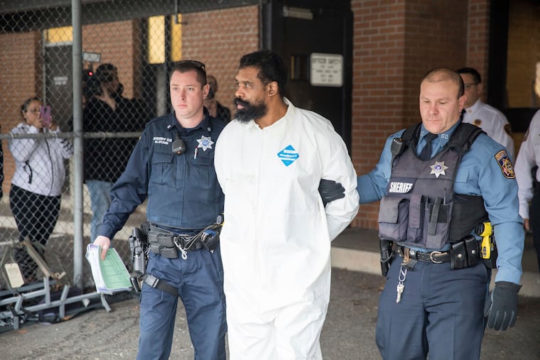 Ramapo police officers escort Grafton Thomas from Ramapo Town Hall to a police vehicle, Sunday, Dec. 29, 2019, in Ramapo, N.Y. Grafton
