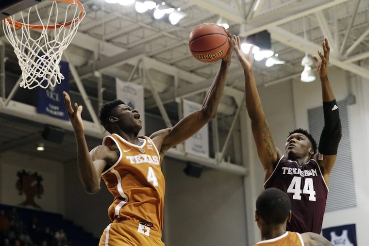 Texas forward Mohamed Bamba (left), a Westtown grad, grabs a rebound from Texas A&M forward Robert Williams in the second half of a college basketball exhibition game. Bamba had a promising debut on Friday.