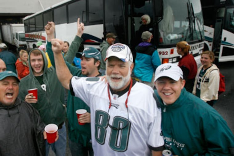 As they prepare to head into the Eagles/Chiefs game, Ron Smith leads the bus in the Eagles chant. The group has been chartering buses to Eagles games for 50 years. (Charles Fox / Staff Photographer)